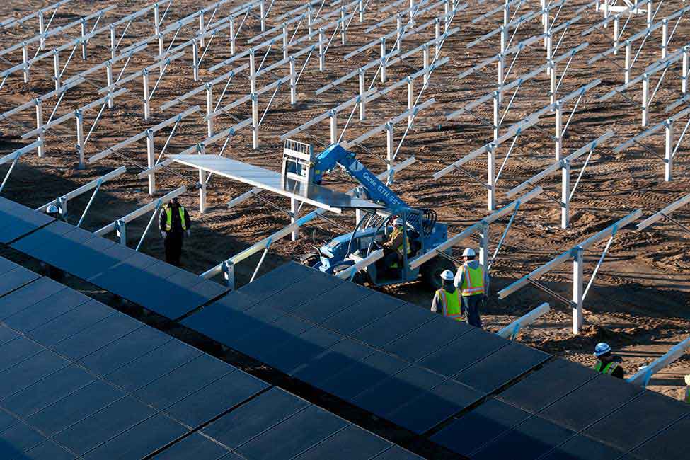 Workers installing the facility’s panels