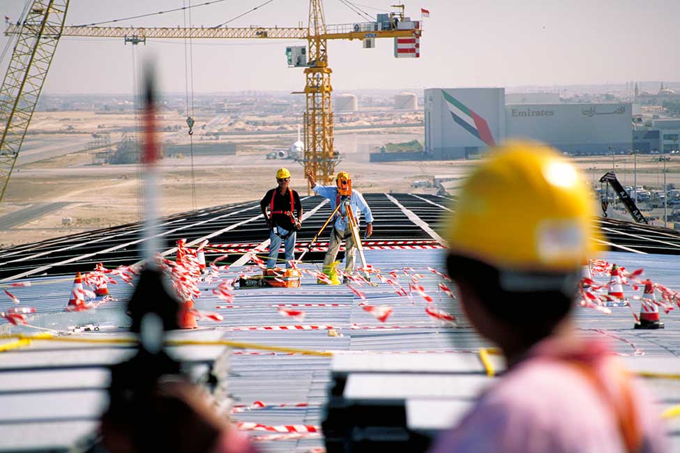 Workers survey the site during construction
