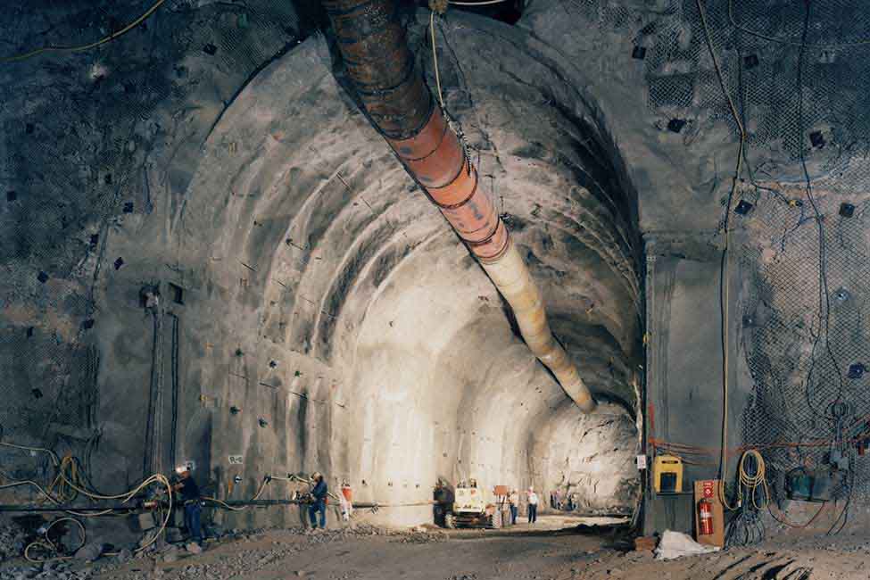 Workers advance construction on a tunnel at the facility