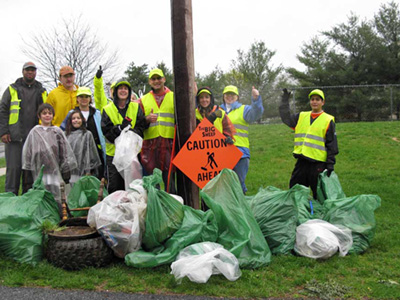 group of people with collected rubbish bags