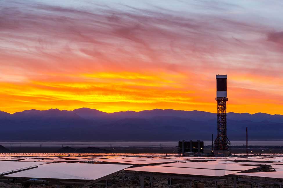 The sun rises over one of Ivanpah’s towers