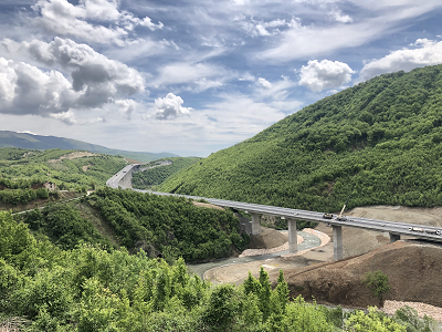 Kosovo roadway, winding through hilly terrain
