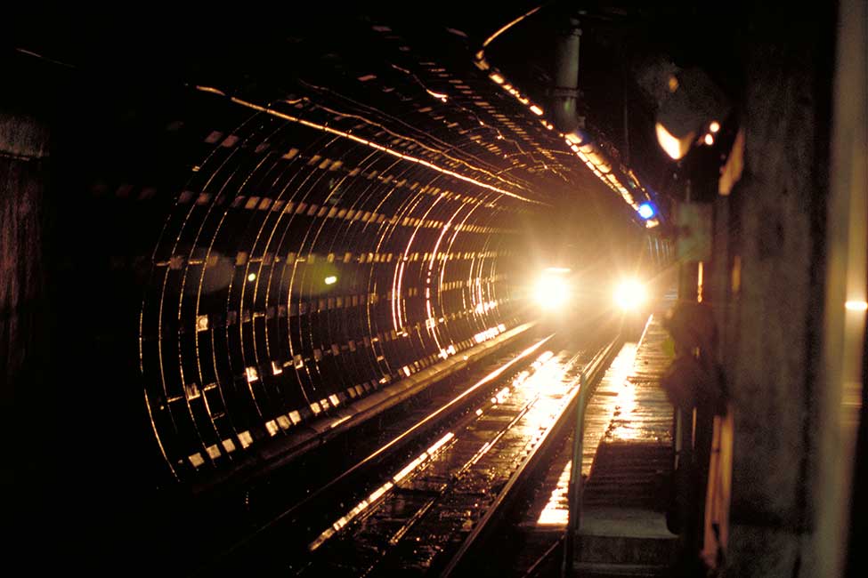 A train travels through one of BART's tunnels