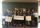 A group of Bechtel interns pose in the lobby holding a sign that reads 'we love our interns'