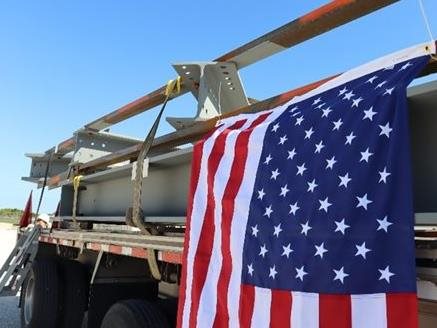 The American flag is displayed as a commemoration of the first steel delivery at NASA’s mobile launcher 2 project. 