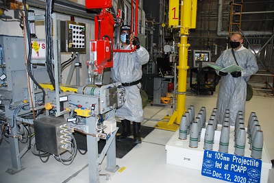 two workers prepare to decommission chemical munitions