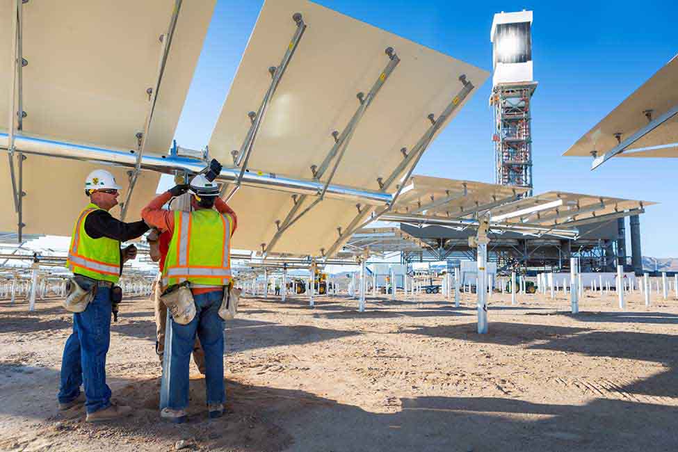 Workers install one of the project’s 173,500 heliostats 