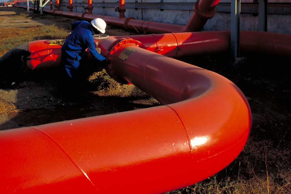 worker inspects a water pipeline