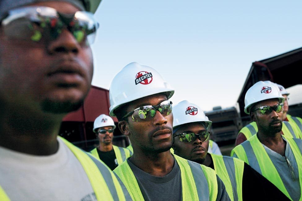 Workers attend a safety briefing; Bechtel employed 2,600 people at peak, with the majority from Mississippi and other Gulf states