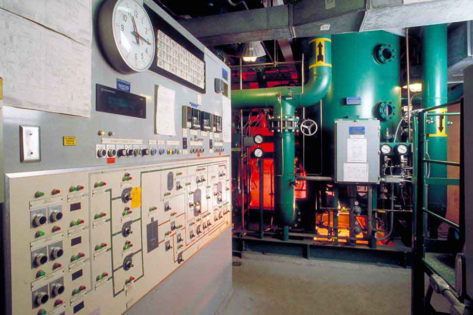 Control panel in a room with piping. 