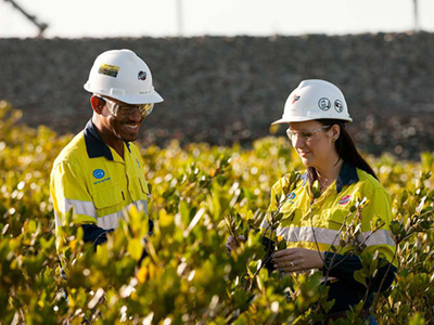 man and woman in hardhats in field