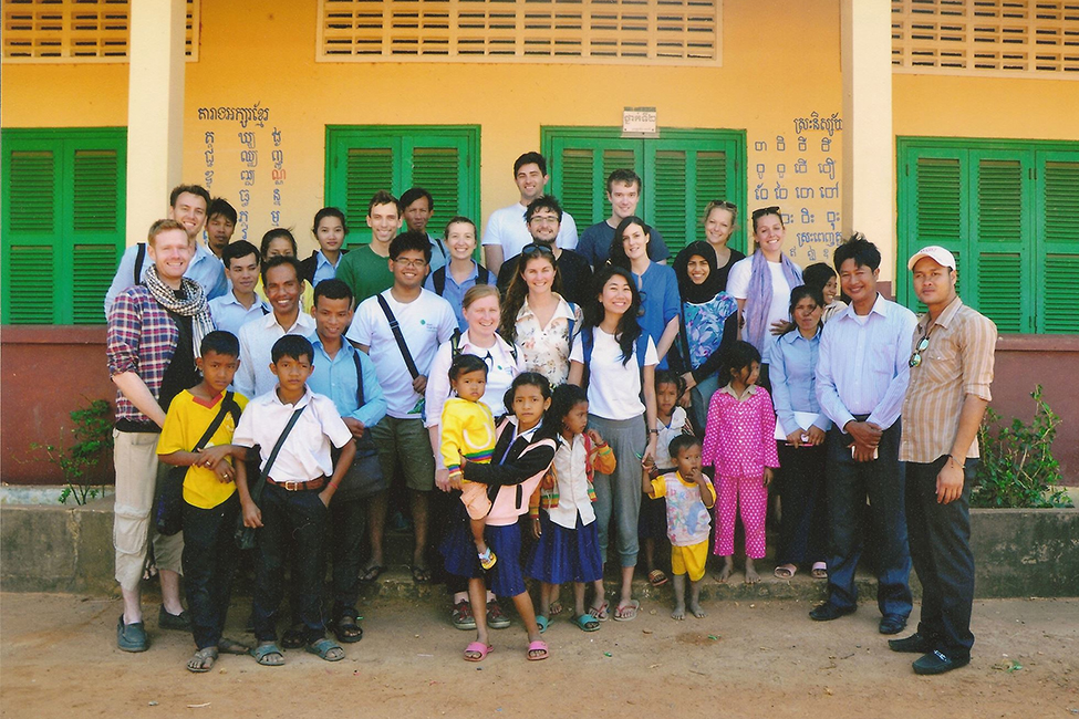 A number of Bechtel employees pose with a large group of school children