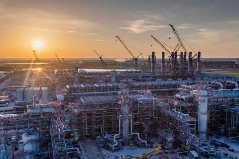 an LNG facility under construction at sunset