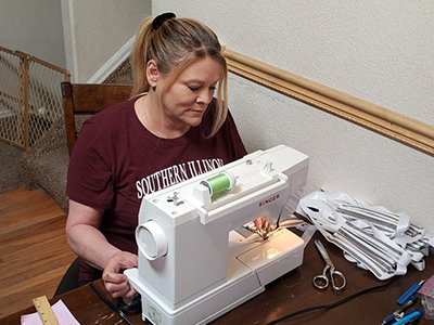 a Bechtel employee at her sewing machine