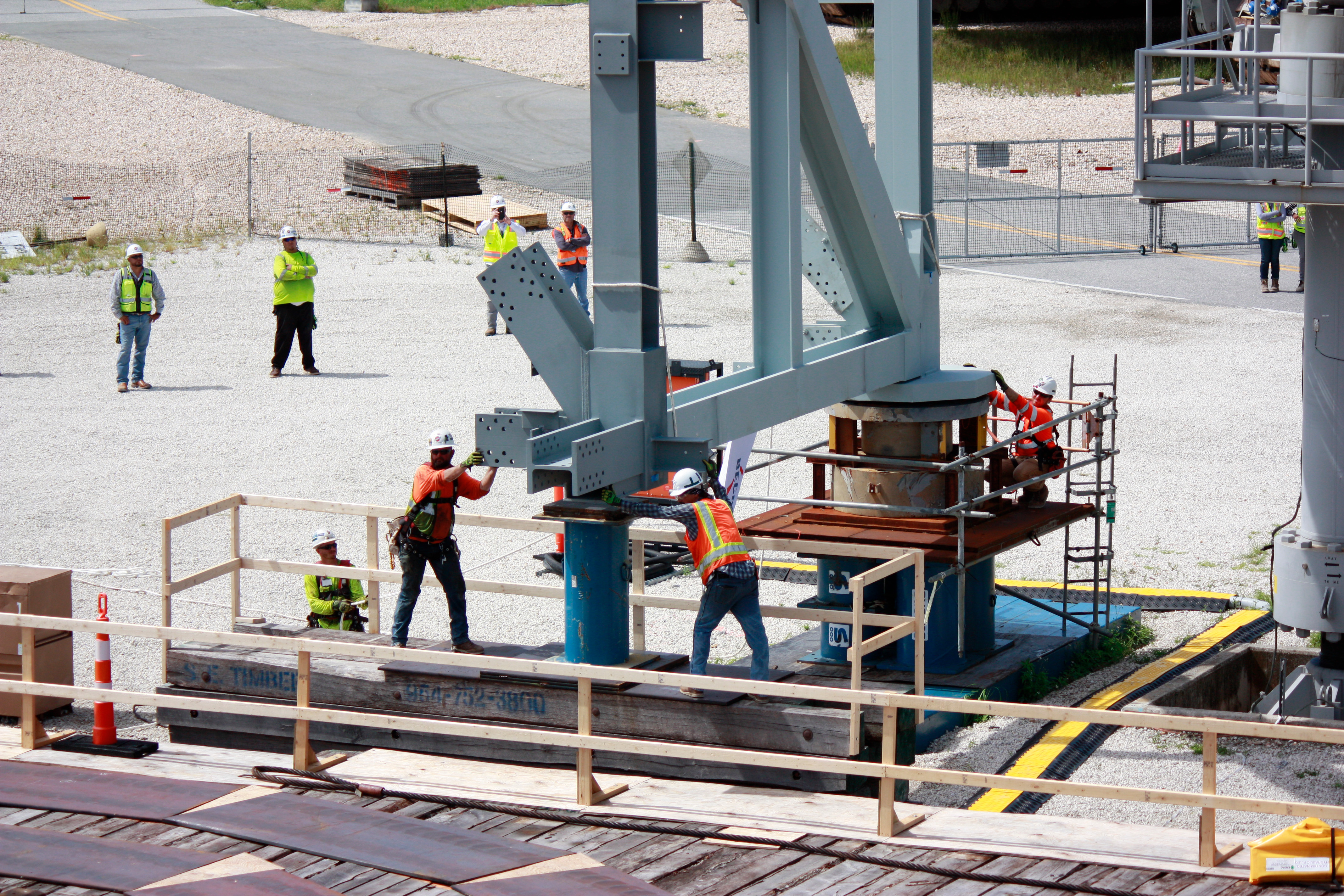 Members of the ML2 craft professional team erect the first piece of steel for the mobile launcher 2 base. 
