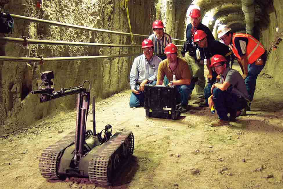 Team members operate one of the facility’s robots