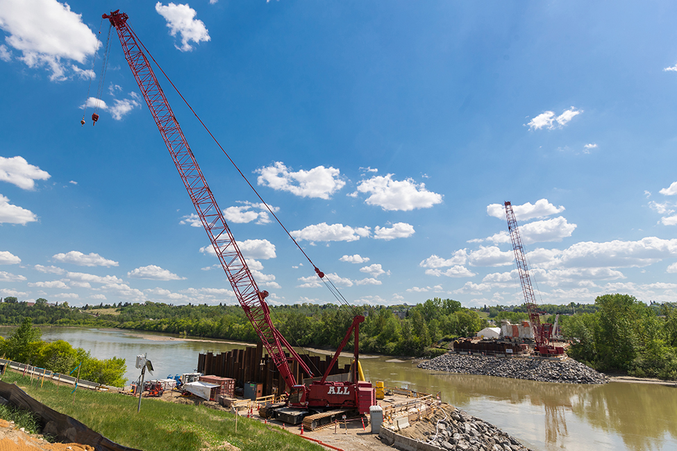 cranes and equipment near body of water