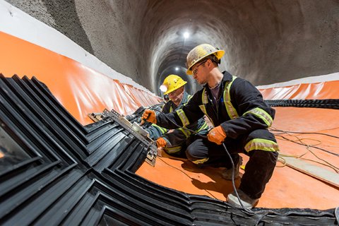 Two engineers working in the Edmonton light rail tunnel