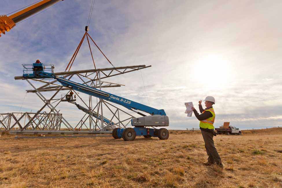 A Bechtel right-of-way field coordinator supervises a tower assembly