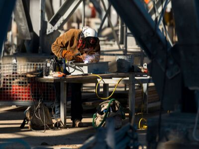 a welder works at his bench on a construction site