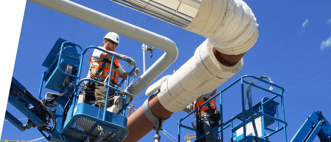 BOF - Employees on lifts install insulation to overhead piping  More than one mile of overhead piping will carry high-pressure steam, steam condensate and chemical reagents between process and support facilities  