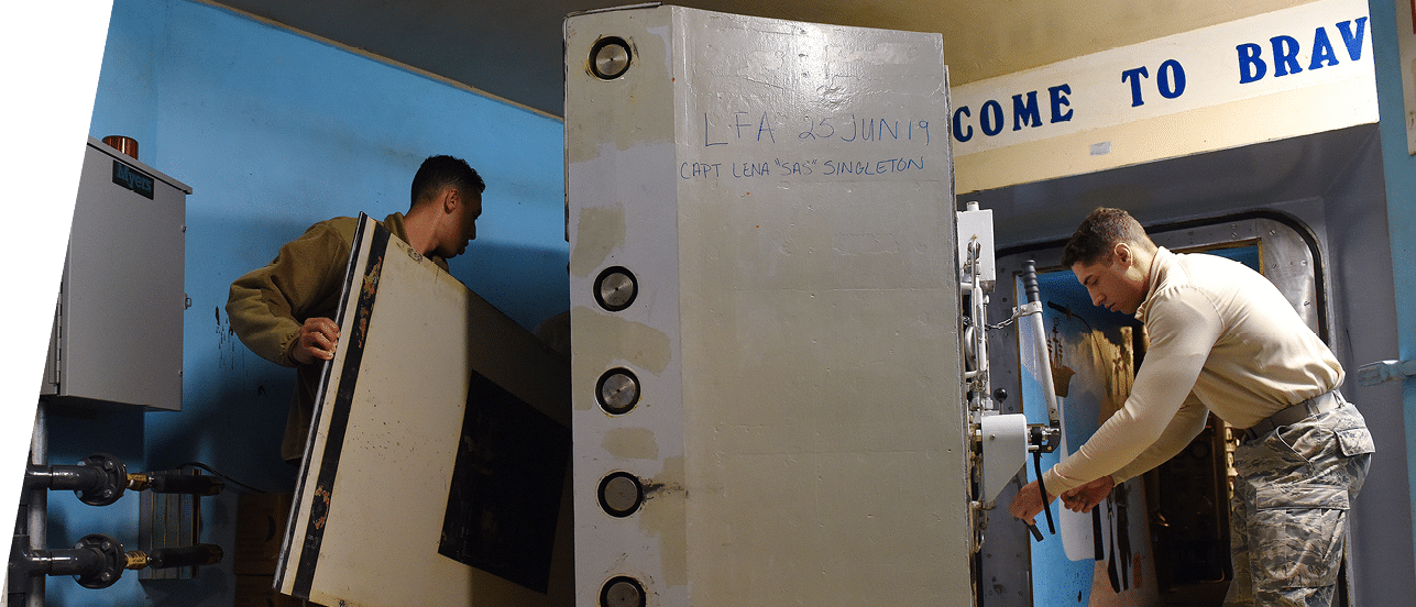 Airman 1st Class Anthony White and Senior Airman Mark McCormick, 341st Missile Maintenance Squadron survivable systems team members, perform maintenance on a launch control center blast door, Oct  29, 2019, at a missile alert facility near Malmstrom Air Force Base, Mont  The survivable systems team s primary task is to perform launch control center maintenance  (U S  Air Force photo by Airman 1st Class Jacob M  Thompson)