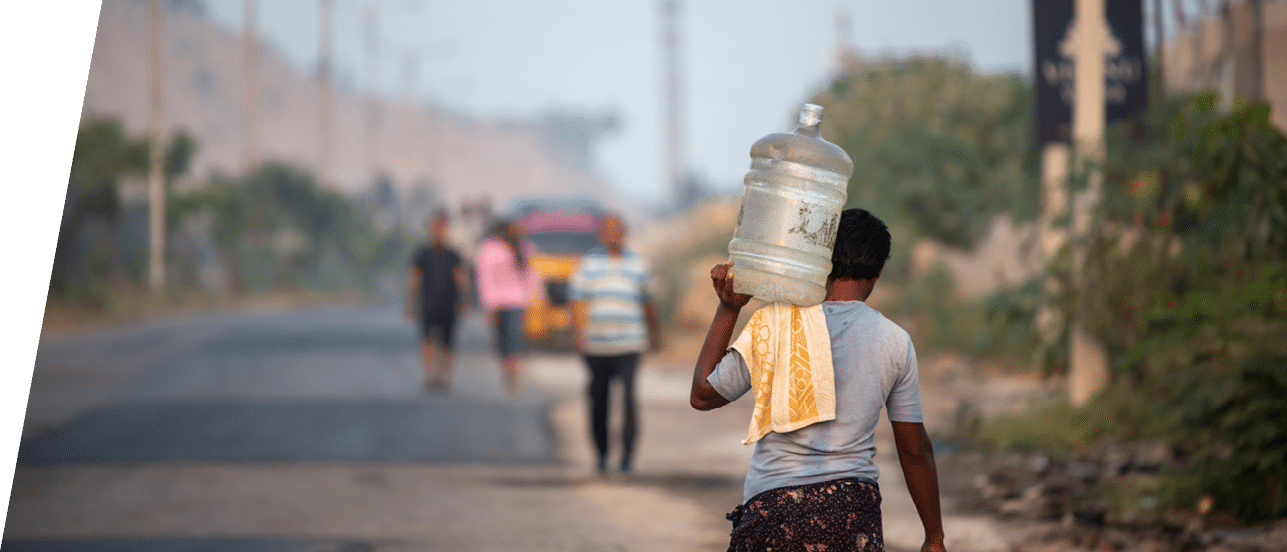 Hyderabad,Telangana,India, November 20, 2019, an Indian man carries water in a plastic can in Kaithalapur,Hyderabad as they face serious water scarcity
