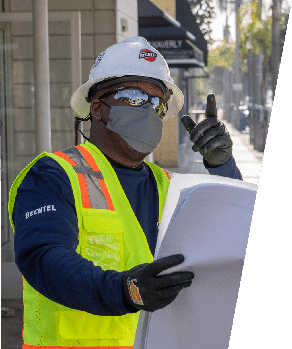 MANHATTAN BEACH, CALIFORNIA - FEBRUARY 11: Bechtel employees look at plans as they perform maintenance work on a cell tower in Manhattan Beach on February 11, 2021 (photo Gilles Mingasson Getty Images for Bechtel)  